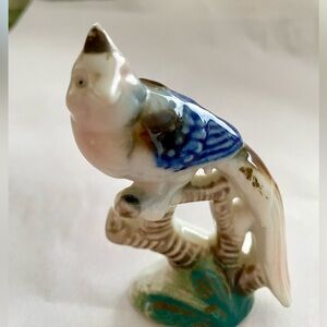 Small Porcelain Figurine of a Bird of Paradise. No chips, some paint has worn.